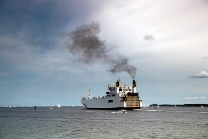 Ship emitting exhaust fumes.