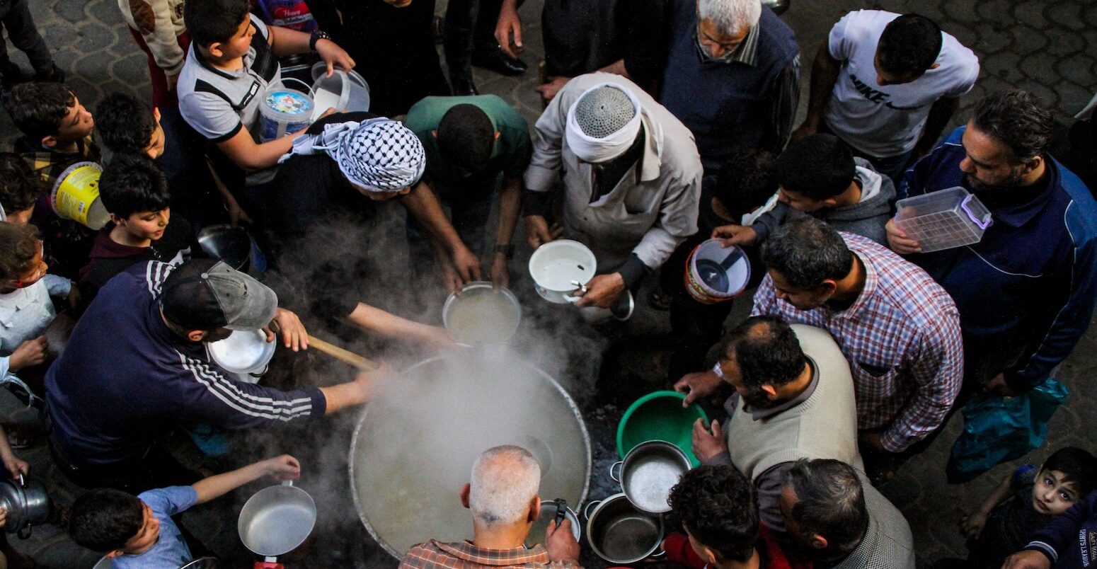 A group of people wait to be served food, Gaza, Palestine.