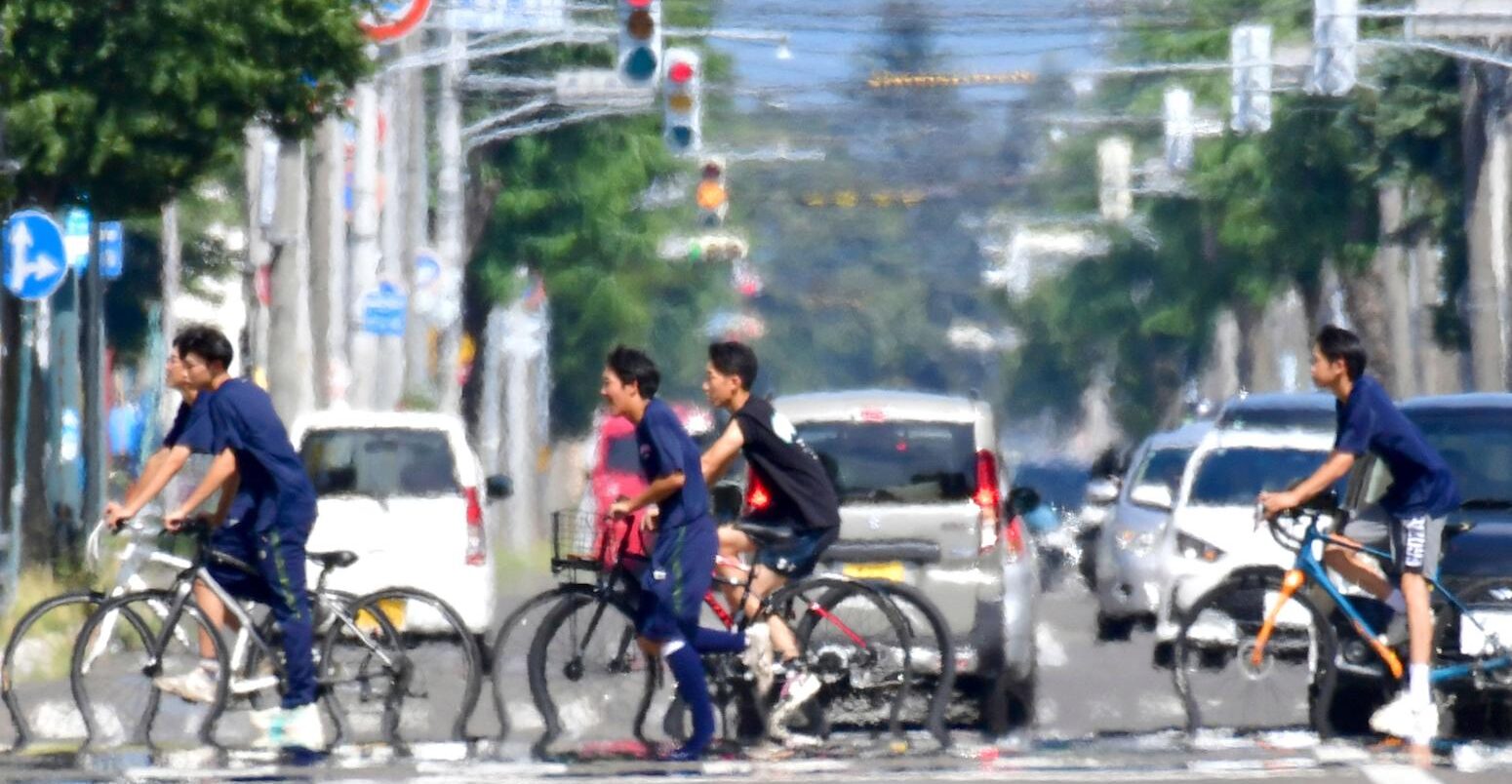 The phenomenon of water mirage in scorching heat in Obihiro City, Hokkaido Prefecture, Japan. Credit: Associated Press.
