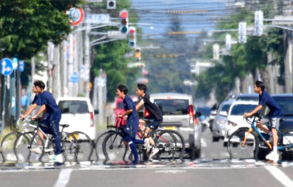 The phenomenon of water mirage in scorching heat in Obihiro City, Hokkaido Prefecture, Japan. Credit: Associated Press.