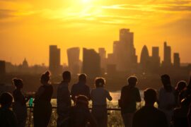 People overlooking London's skyline during a heatwave.