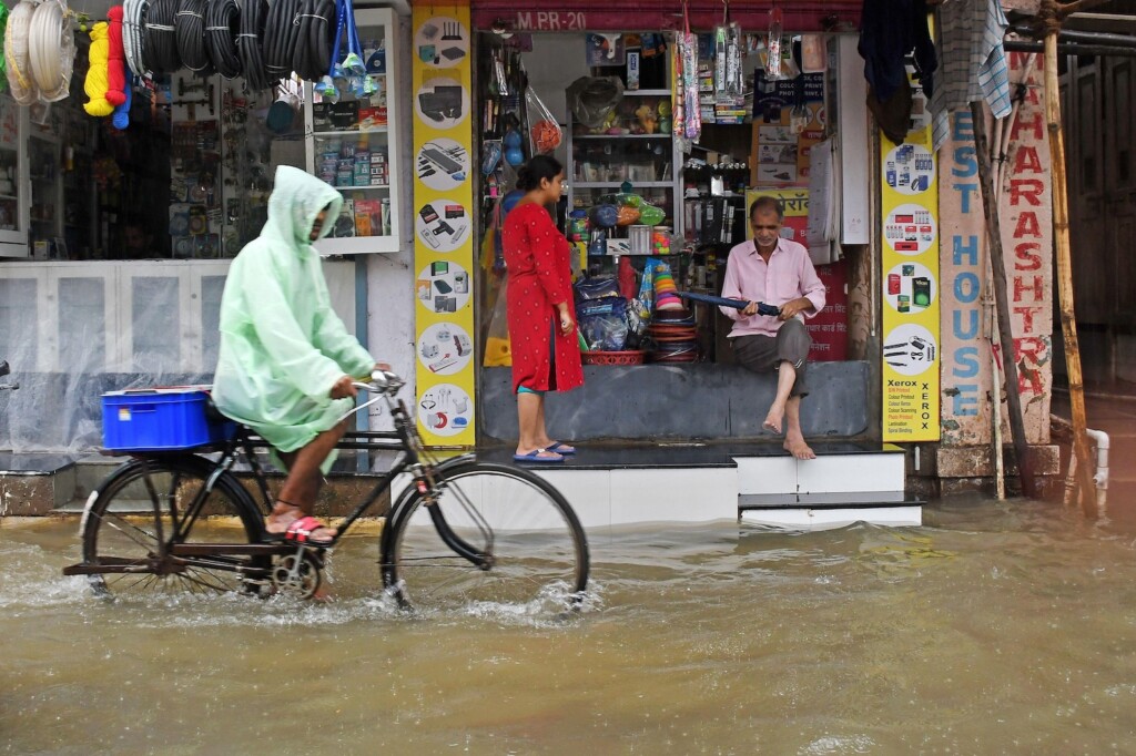 A cyclist goes through heavy rain and flooding in Mumbai, India.