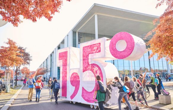 Demonstrators from Extinction Rebellion push self-made cart in the shape of the 1.5 climate target in Berlin, Germany.