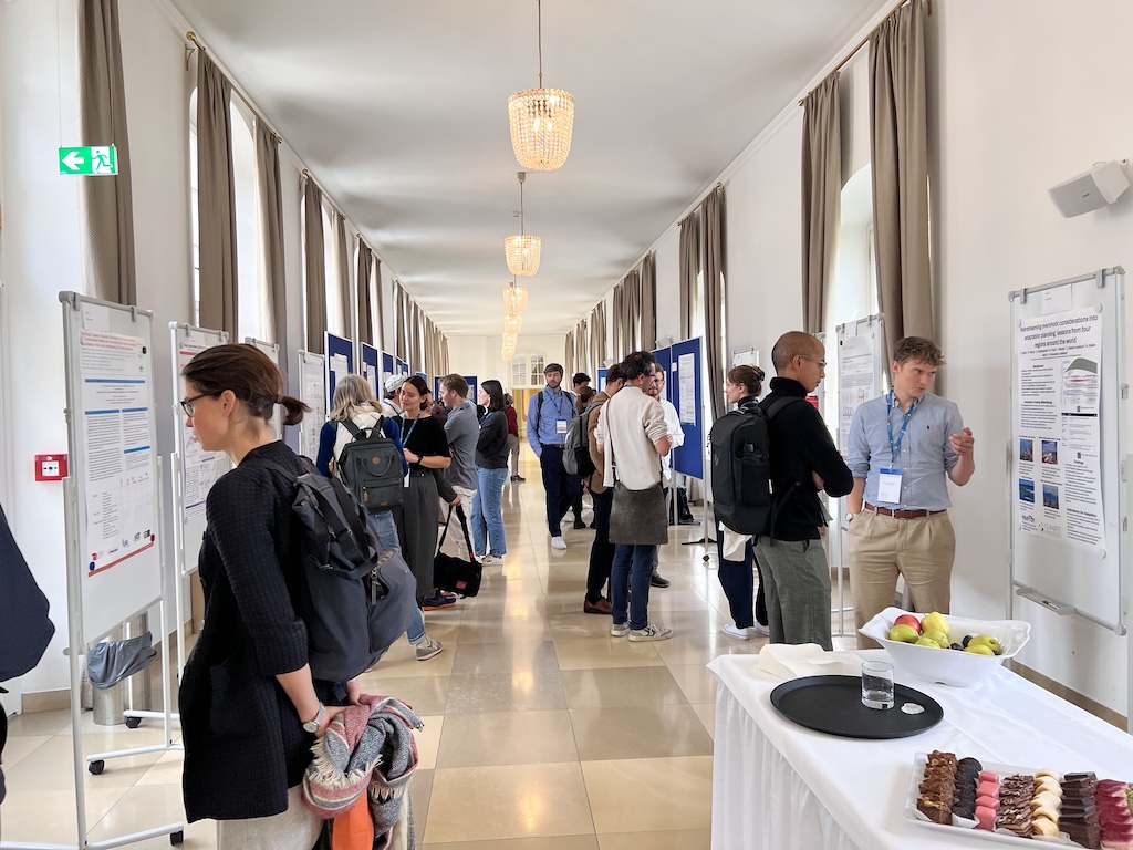 Delegates attend a poster session at the Overshoot Conference. Credit: IIASA