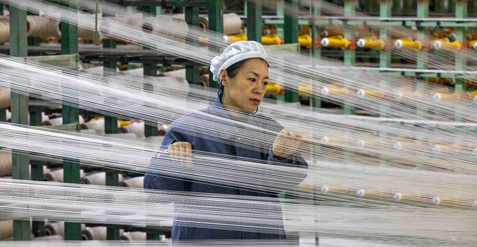 Worker at a chemical fibre plant, China.