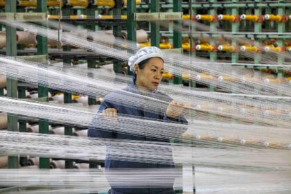 Worker at a chemical fibre plant, China.