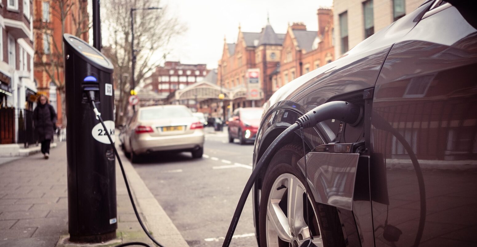 Electric car charging on London street.