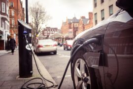 Electric car charging on London street.