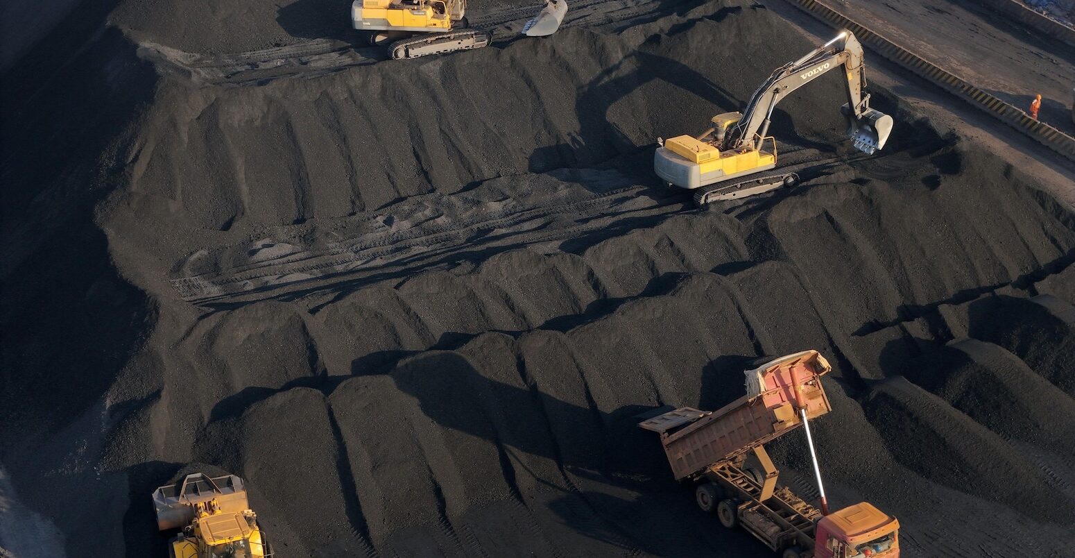 Machines work at a coal storage dock in China's Shandong province on 14 November 2025.