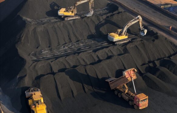 Machines work at a coal storage dock in China's Shandong province on 14 November 2025.