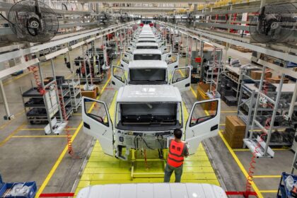 An employee operates at an assembly line of new energy light trucks in Guizhou, China.