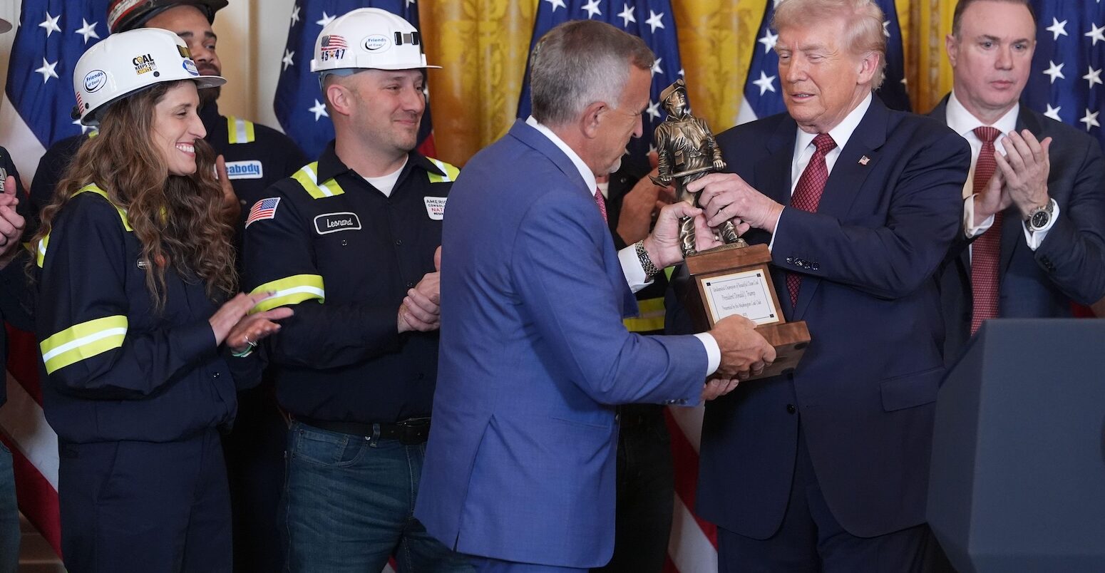 President Donald Trump is presented a trophy by Jim Grech, president and CEO of Peabody Energy and chair of the National Coal Council (NCC), during an event on coal power in the East Room of the White House, Wednesday, Feb. 11, 2026, in Washington.