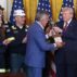President Donald Trump is presented a trophy by Jim Grech, president and CEO of Peabody Energy and chair of the National Coal Council (NCC), during an event on coal power in the East Room of the White House, Wednesday, Feb. 11, 2026, in Washington.
