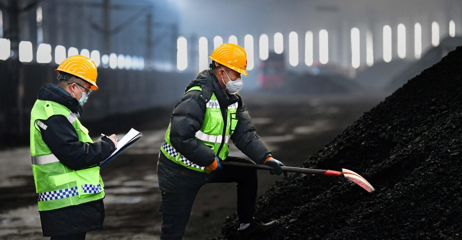 Workers check coal quality at the Buertai coal mine in Inner Mongolia, China.