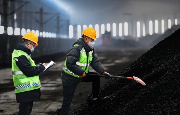 Workers check coal quality at the Buertai coal mine in Inner Mongolia, China.