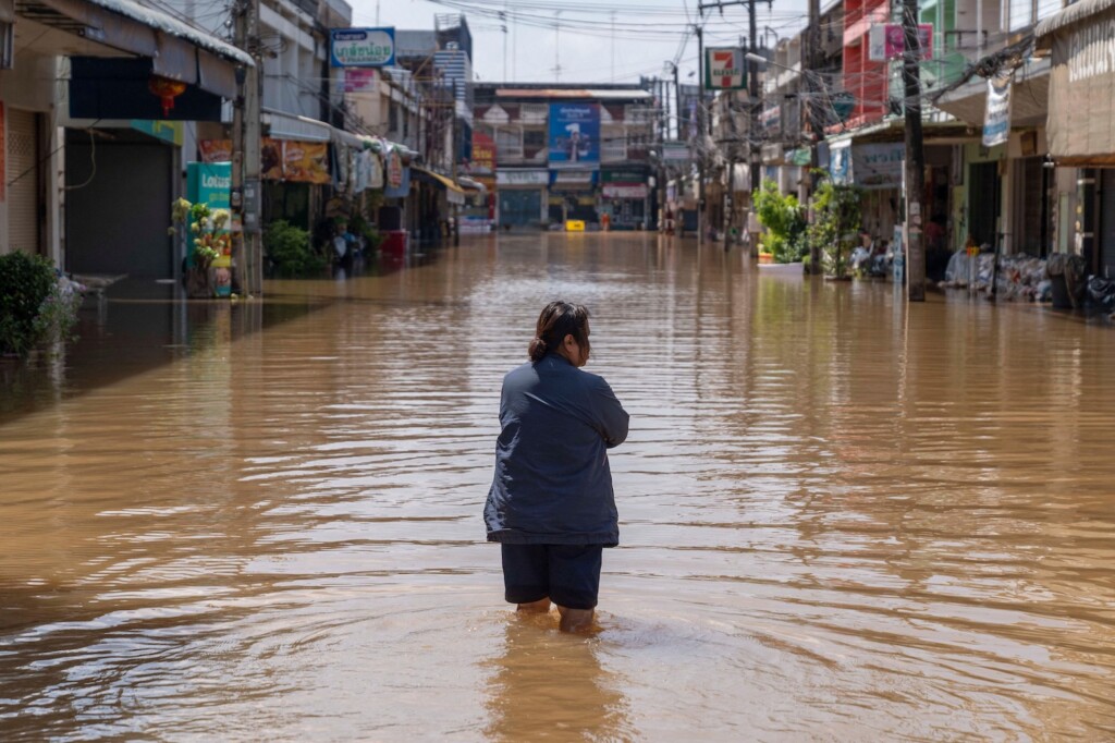 A resident walks through inundated streets in Nong Khai city, Thailand
