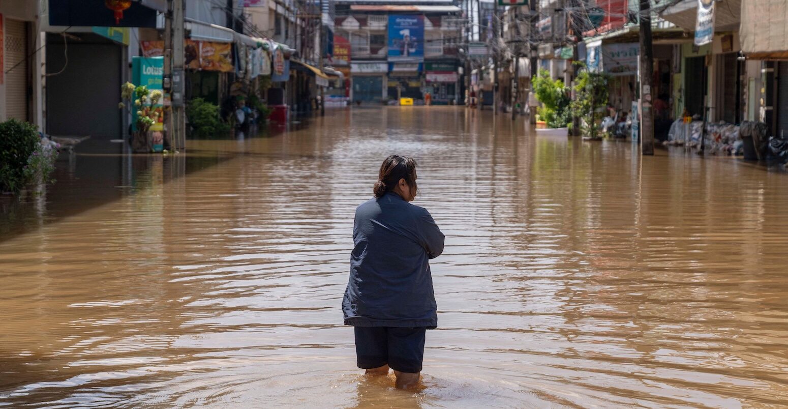 A resident walks through inundated streets in Nong Khai city, Thailand
