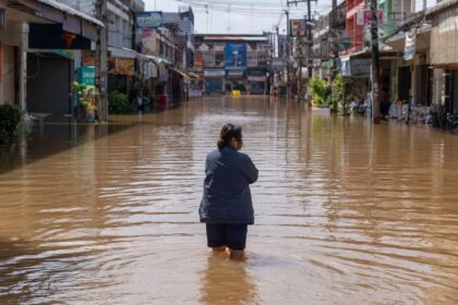 A resident walks through inundated streets in Nong Khai city, Thailand