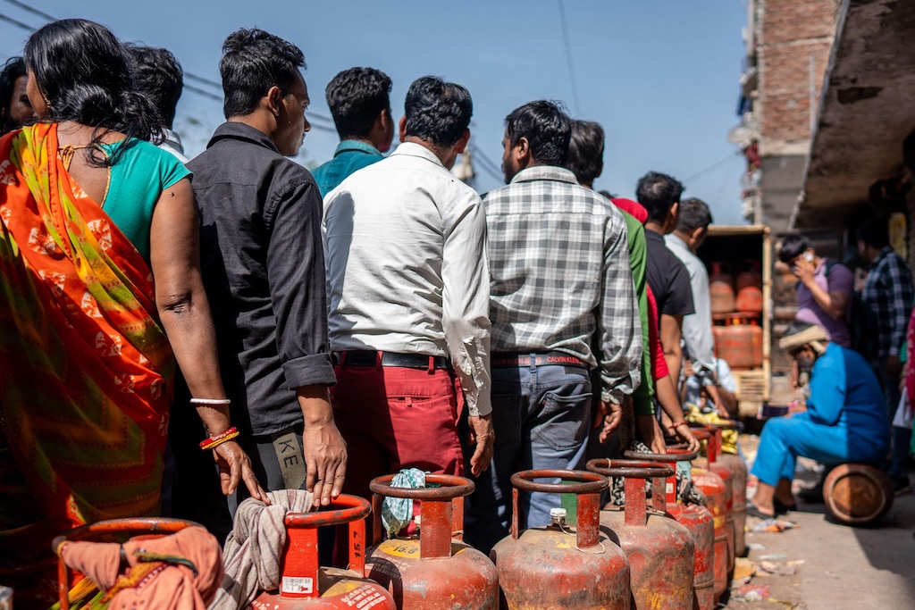 Men and women wait in long queues for cooking gas refills at a depot in Noida. Credit: Alamy Stock Photo. Image ID: 3E2CRC9.