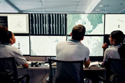 Scientists track weather data in a control room.
