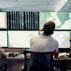 Scientists track weather data in a control room.