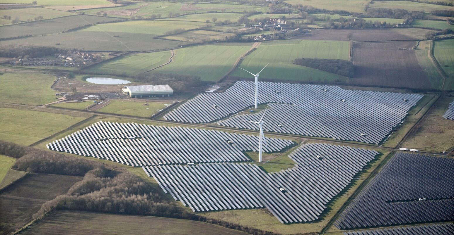 Aerial view of a solar farm and wind turbines, in the East Midlands, UK.