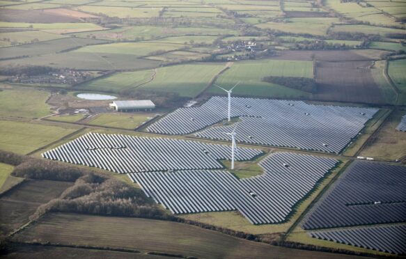 Aerial view of a solar farm and wind turbines, in the East Midlands, UK.