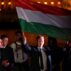Peter Magyar, leader of Hungary's Tisza Party, waves the Hungarian national flag at an election victory rally.