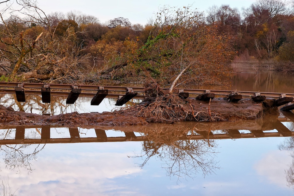 Rail track dangling after heavy snow and floods at Stover Canal, Newton Abbot, Devon.