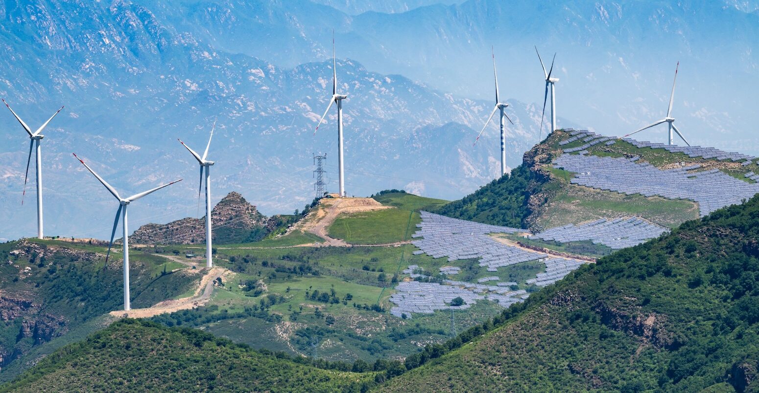 Solar panels and wind turbines on the hills outside Beijing, China.