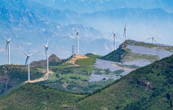 Solar panels and wind turbines on the hills outside Beijing, China.