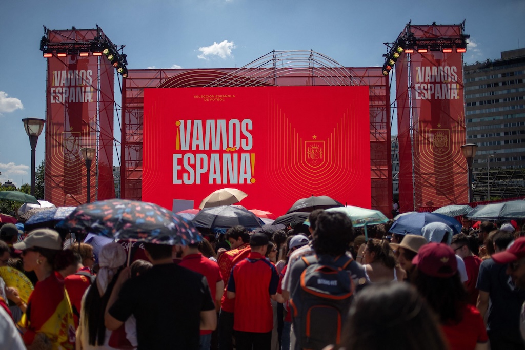 Dozens of fans seek refuge from the Madrid heat during a World Cup game. 