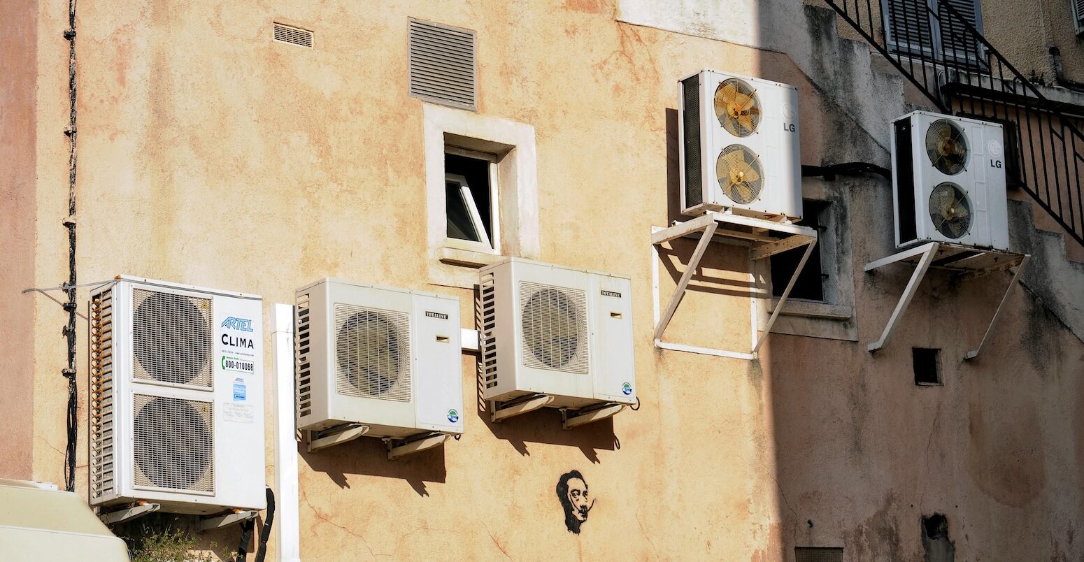Air conditioners on the wall of a house in Corsica, France.