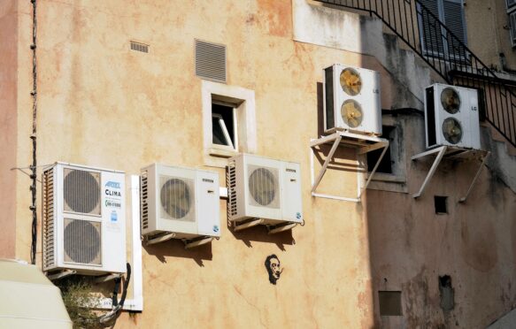 Air conditioners on the wall of a house in Corsica, France.