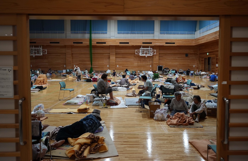 Evacuees shelter in a school gymnasium following the 7.1 magnitude earthquake in Kumamoto.